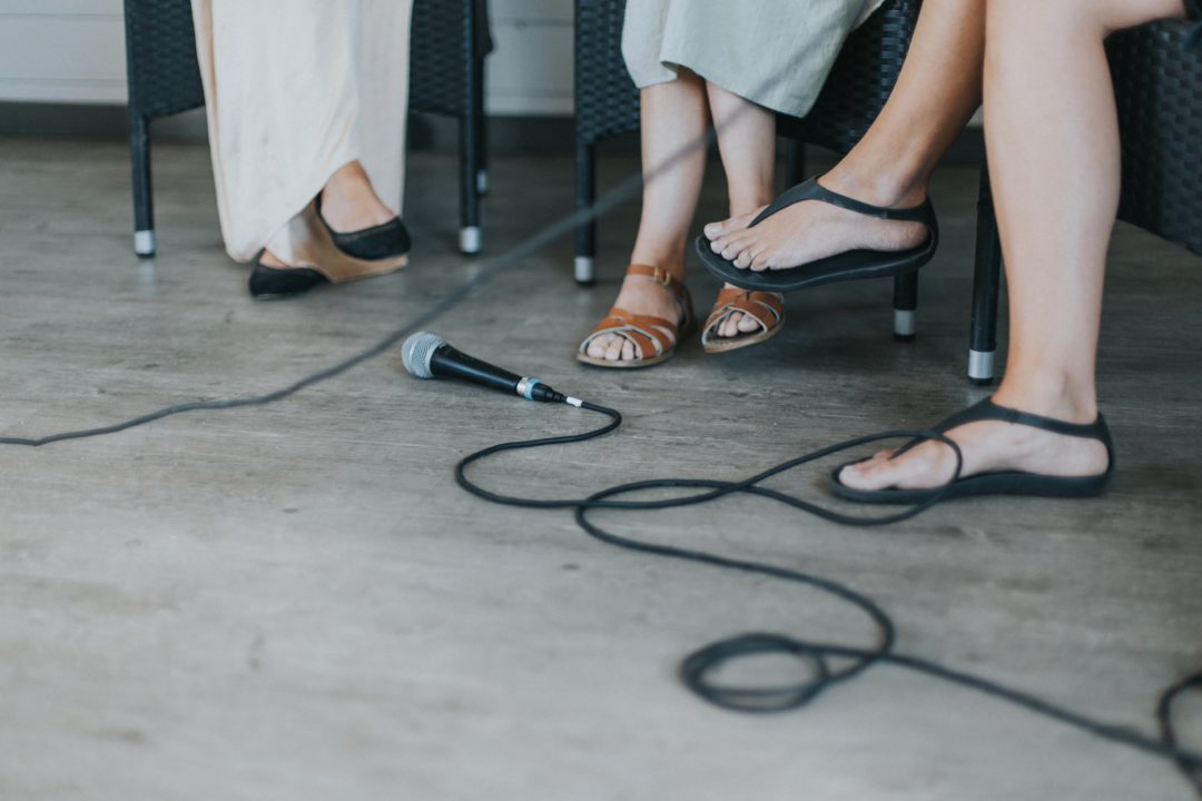 microphone by feet of women sitting around